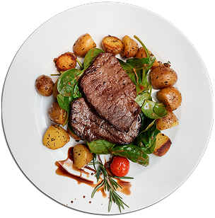 Grilled steak with roasted potatoes and greens