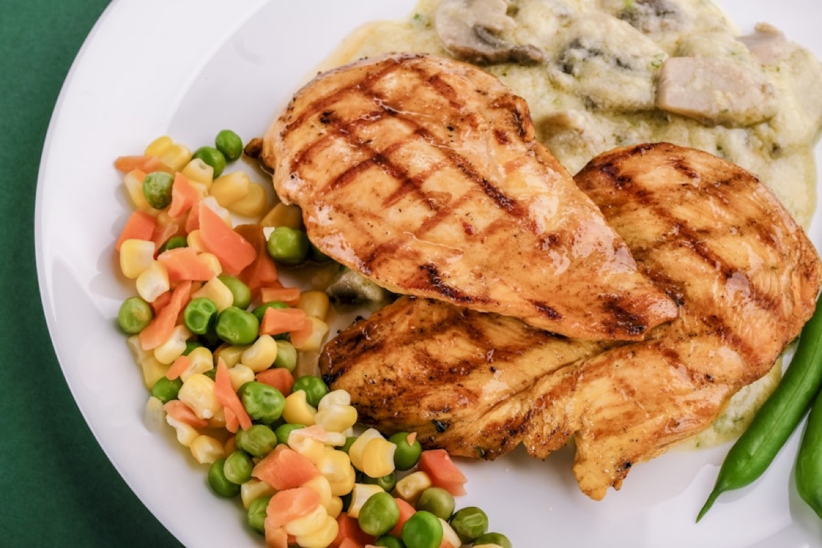 Grilled chicken with caramelized onions and fresh herbs